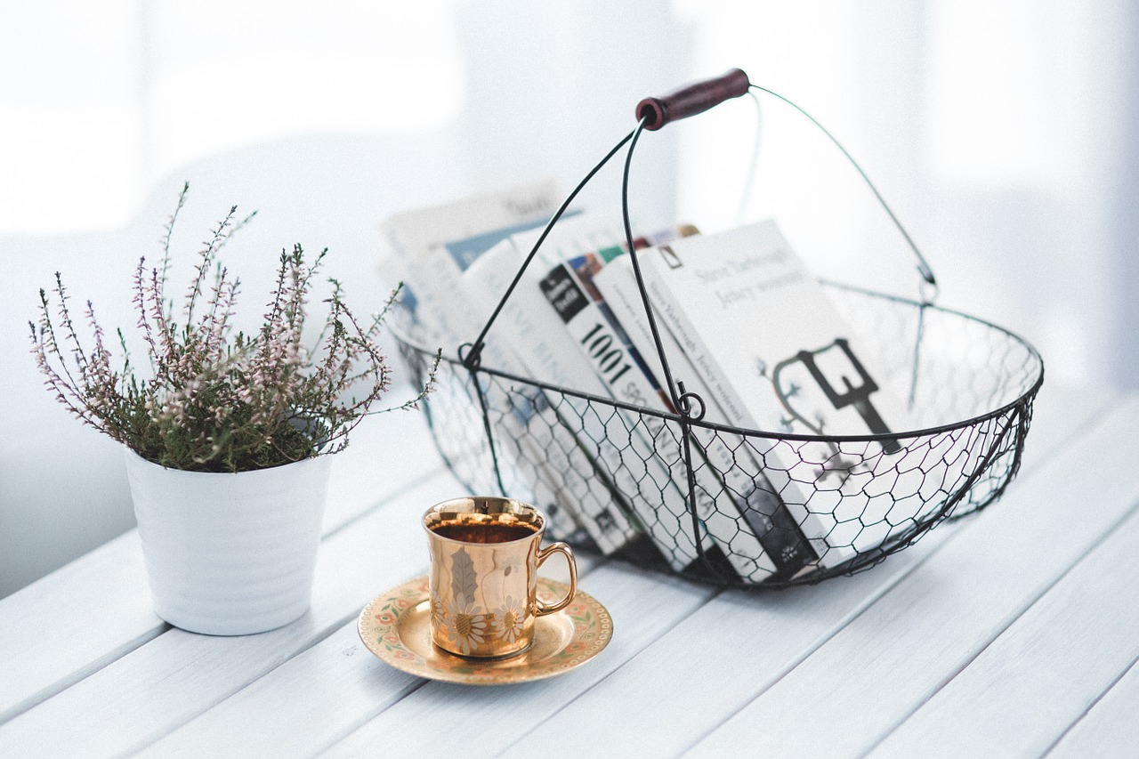 a tea cup,books and flower vase